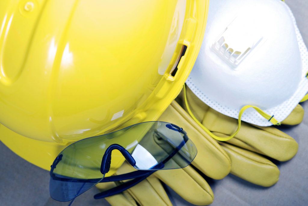 Safety Protective Work Equipment. Yellow Helmet, Glasses, Gloves and Mask. Protection Gear Closeup.